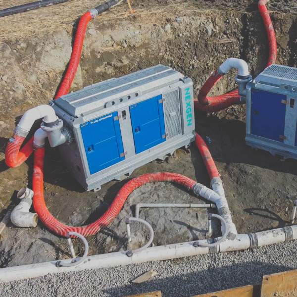 Two wellpoint systems units with hoses on a project site for efficient dewatering.